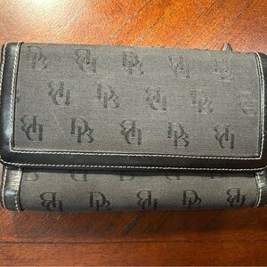 Dooney & Bourke Black Logo Fold Wallet It has a small detail on the inside